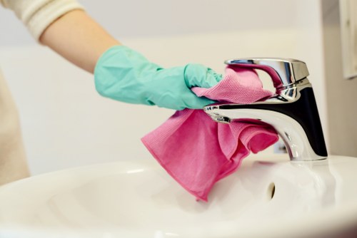 Professional carpet cleaner in Hackney deep cleaning a living room carpet