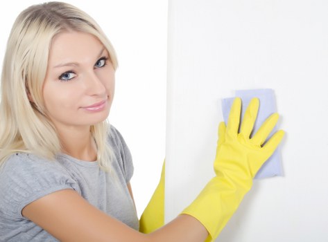 Professional cleaner restoring a kitchen during one off cleaning in Hackney